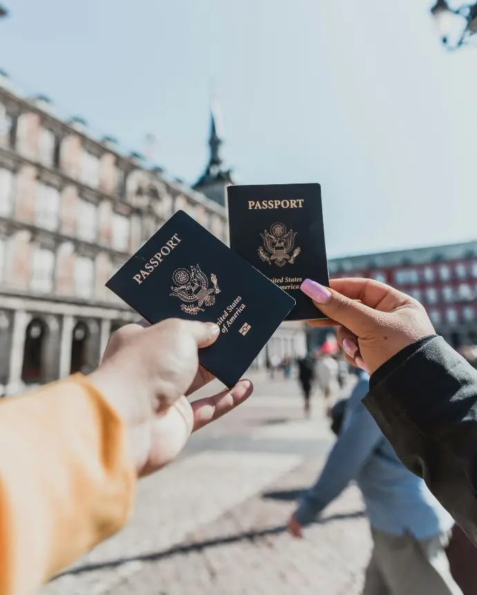 Hands holding passports outdoors, symbolizing TRC and work-permit support for foreign founders