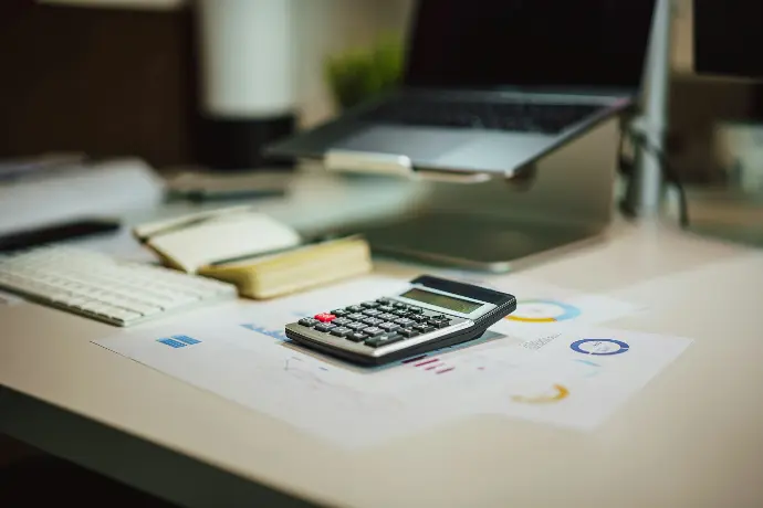 Calculator and documents on desk