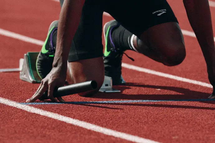 Athlete at track starting line, representing fast and compliant business setup with Smart Start