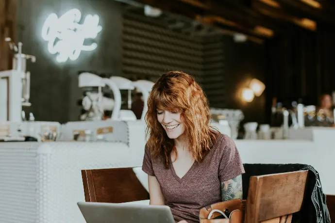 Woman working on laptop in room
