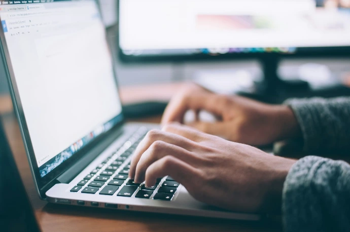 Hands typing on a laptop keyboard during digital setup