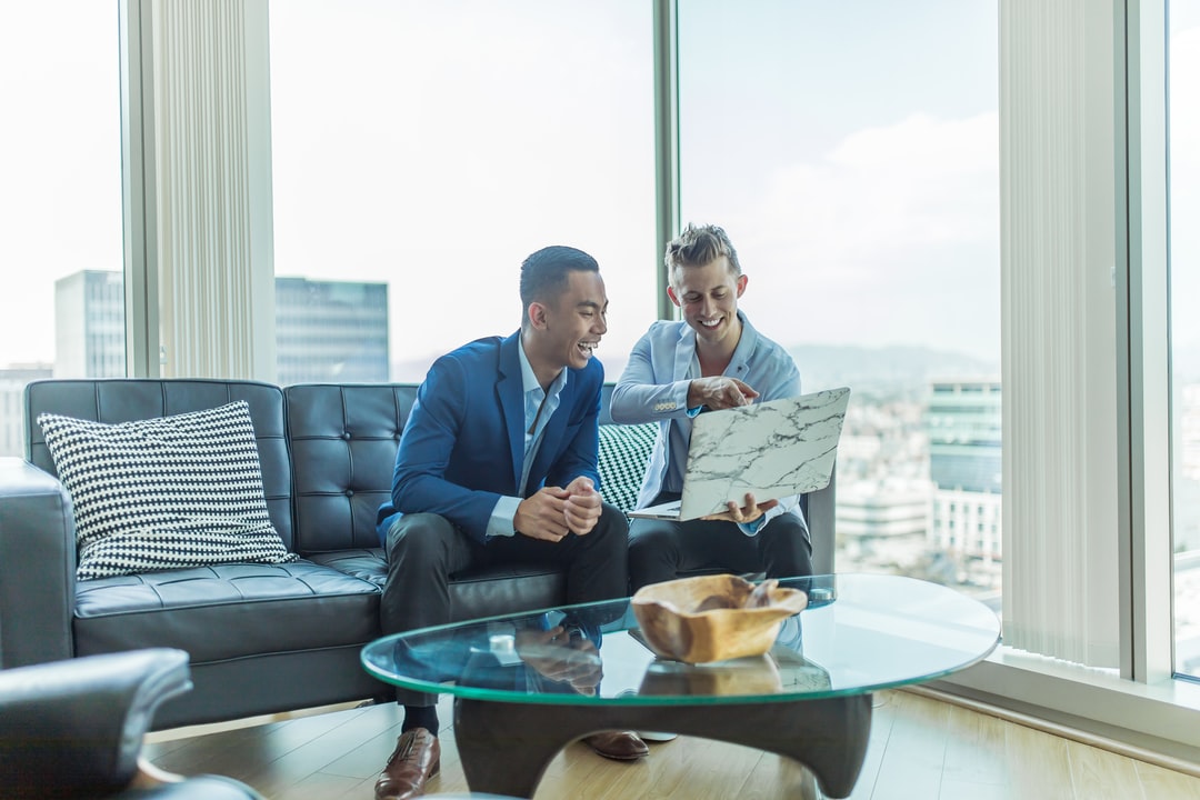 Two men discussing business in a modern office lounge